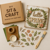 Sit Back & Craft DIY Box featuring a spring-themed craft project with decorative elements including a wooden sign, florals, and craft supplies.