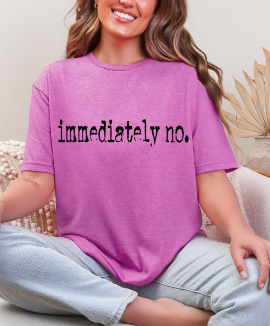 Group of friends laughing, one wearing the Sassy 'Immediately No' Graphic Tee, demonstrating its appeal for social gatherings.