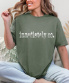 Flat lay of the Sassy 'Immediately No' Graphic Tee styled with accessories, perfect for layering or wearing solo.