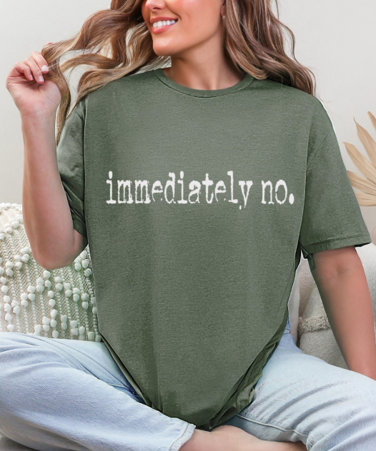 Flat lay of the Sassy 'Immediately No' Graphic Tee styled with accessories, perfect for layering or wearing solo.