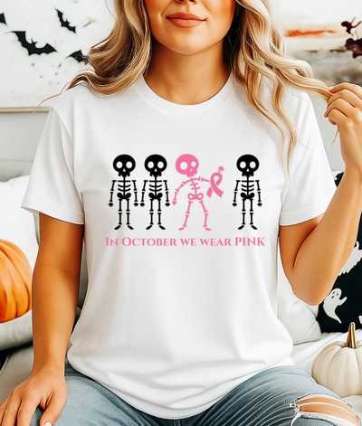 In October We Wear Pink Skeletons Unisex Softstyle T-Shirt – Breast Cancer Awareness Halloween Tee