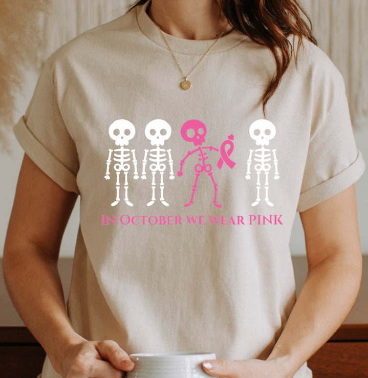 In October We Wear Pink Skeletons Unisex Softstyle T-Shirt – Breast Cancer Awareness Halloween Tee