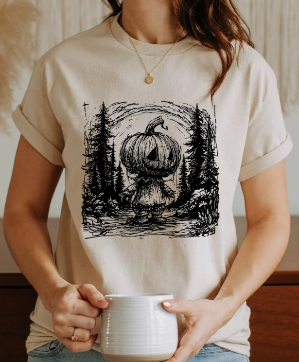 Pumpkin Head Forest Scene Unisex Softstyle T-Shirt – Spooky Halloween Graphic Tee