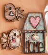 Sit Back & Craft DIY Box with charming wooden decorations featuring birds and a birdhouse, bringing a cozy home touch to your craft projects.