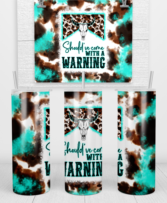 Warning Tumbler - Double Wall Insulated, Available in 20oz & 30oz with Lid & Straw featuring a stylish design of a cow head against a turquoise background with cow print accents. This sublimation tumbler showcases the phrase 'Should've come with a WARNING', perfect for anyone looking for a unique drinkware option.